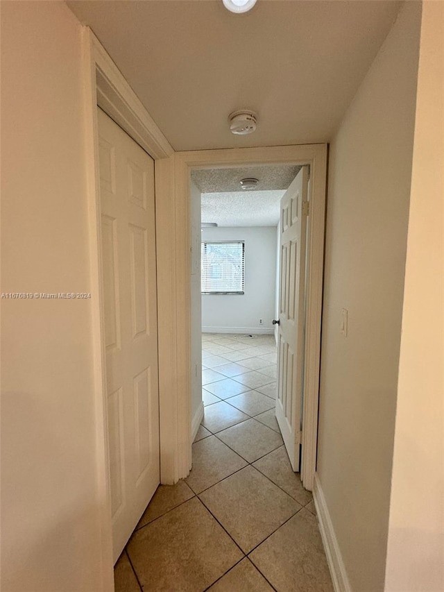 9200 W Atlantic Blvd Unit 1427, Coral Springs, FL 33071 - corridor featuring light tile patterned floors and baseboards