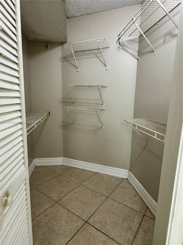 spacious closet with tile patterned flooring