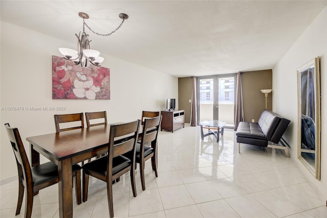 dining room featuring a chandelier, french doors, and light tile patterned floors