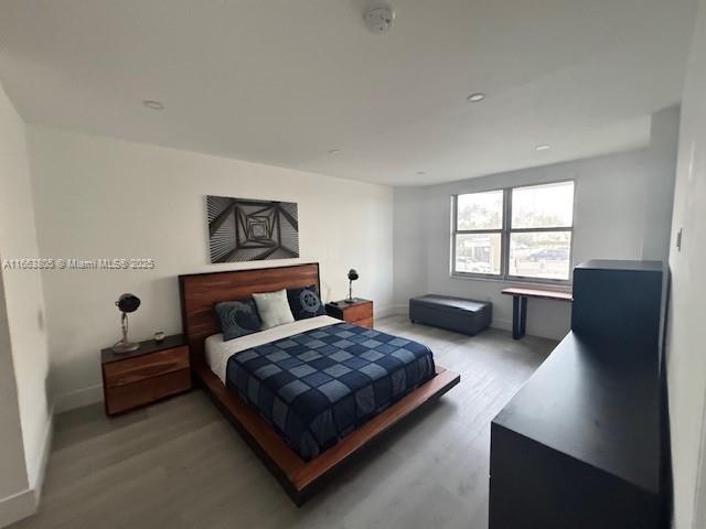 bedroom with hardwood / wood-style flooring