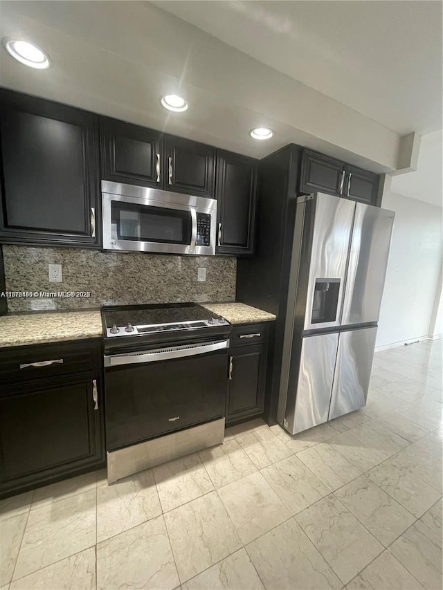 kitchen with decorative backsplash and appliances with stainless steel finishes