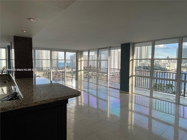 interior space featuring light tile patterned floors and expansive windows