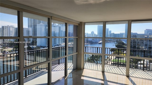 sunroom / solarium with a water view and a healthy amount of sunlight