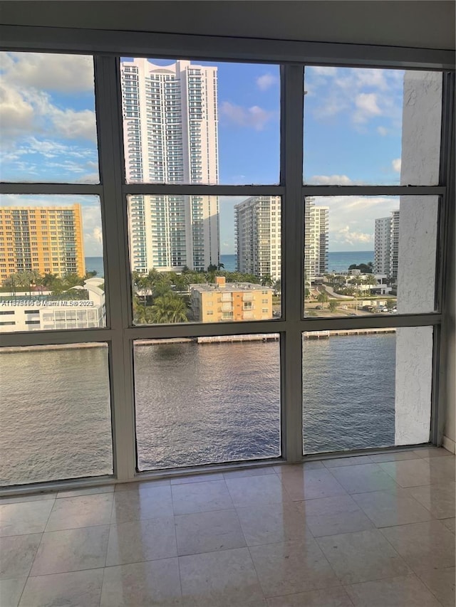 doorway featuring a water view and a healthy amount of sunlight