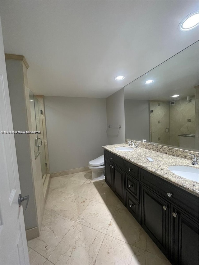 bathroom with vanity, toilet, and an enclosed shower