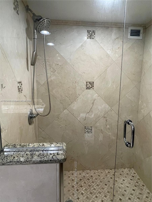 bathroom with a shower with shower door