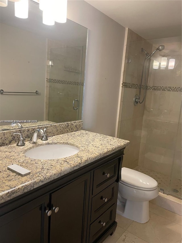 bathroom with walk in shower, tile patterned flooring, vanity, and toilet