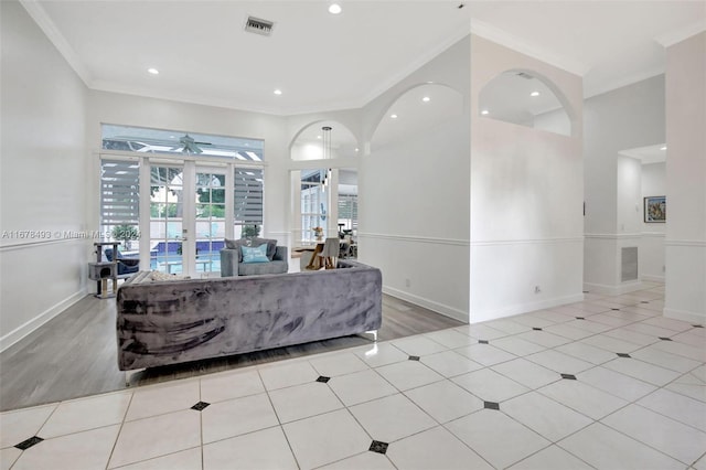 living room featuring light hardwood / wood-style floors, french doors, ceiling fan, and crown molding