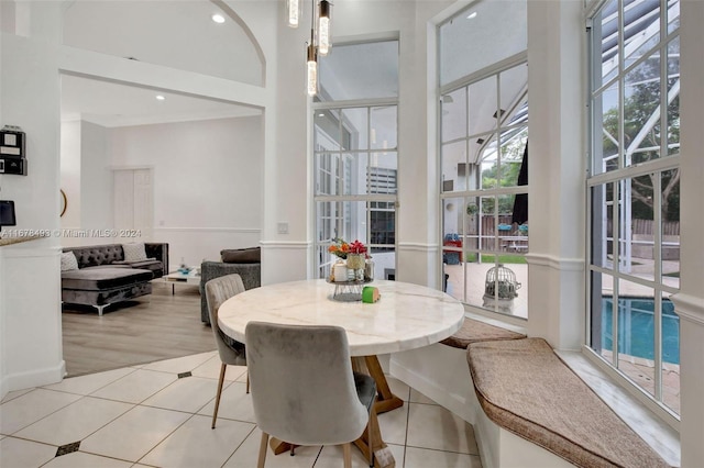 dining area featuring crown molding and light tile patterned floors