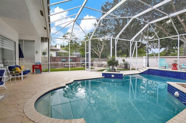 view of pool with a patio and a lanai