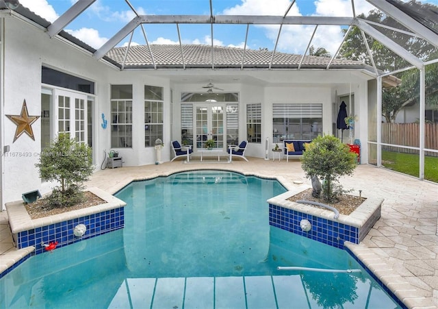 view of swimming pool with a lanai, a patio, and ceiling fan