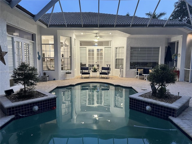 view of pool with ceiling fan, a patio, and a lanai