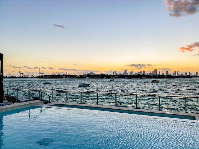 view of pool at dusk