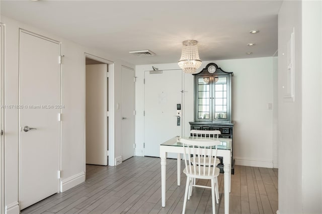 dining area with a chandelier and wood-type flooring