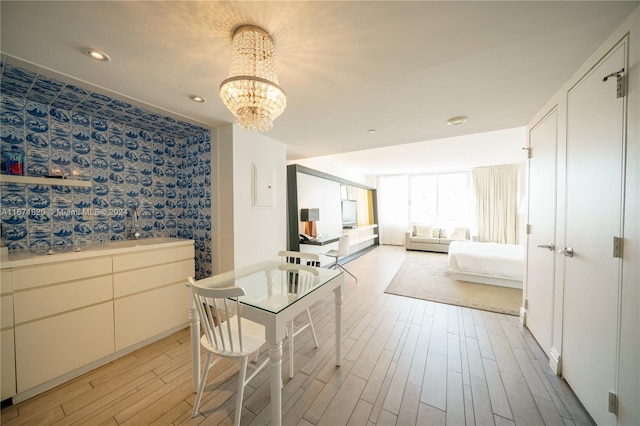 interior space with light hardwood / wood-style flooring and an inviting chandelier