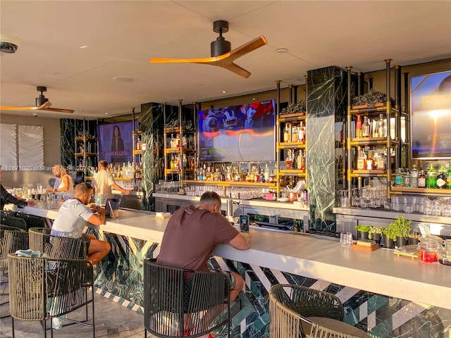 interior space featuring bar area and ceiling fan