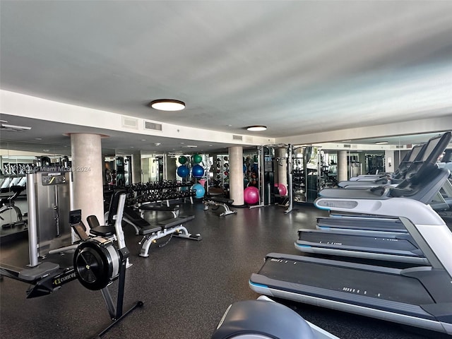 workout area featuring ornate columns