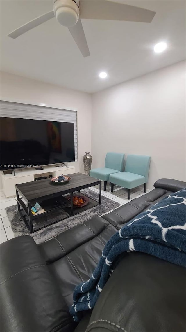 living room featuring ceiling fan and light tile patterned flooring