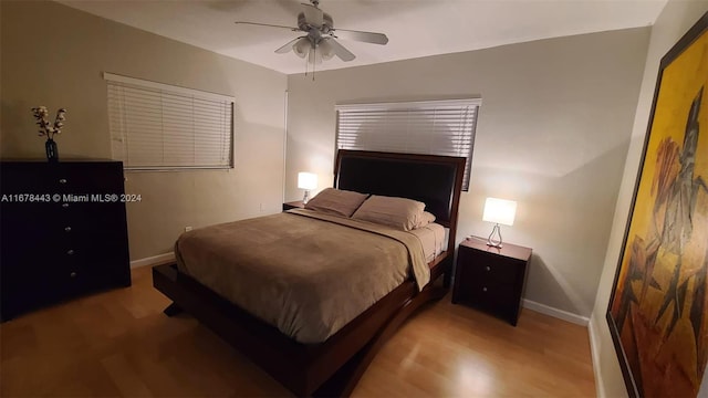 bedroom with ceiling fan and light hardwood / wood-style flooring