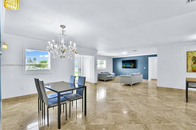 dining room featuring a healthy amount of sunlight, ornamental molding, and a chandelier