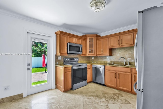 kitchen with backsplash, appliances with stainless steel finishes, sink, crown molding, and light stone counters