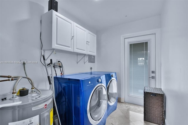 clothes washing area with cabinets, electric water heater, washing machine and clothes dryer, and light tile patterned floors