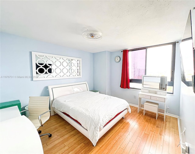 bedroom with hardwood / wood-style flooring