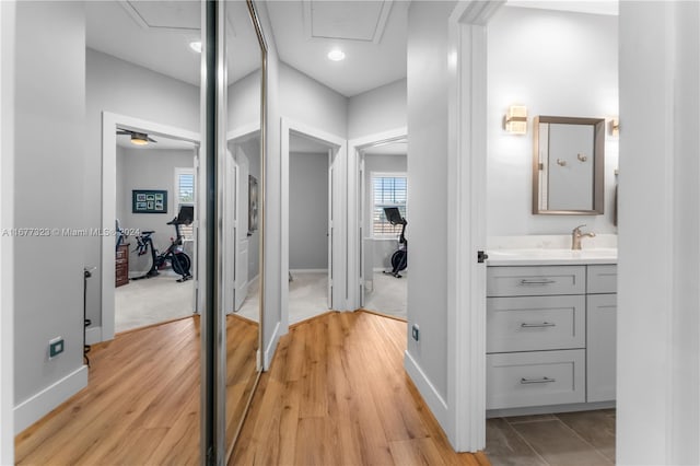 corridor featuring light hardwood / wood-style floors and sink