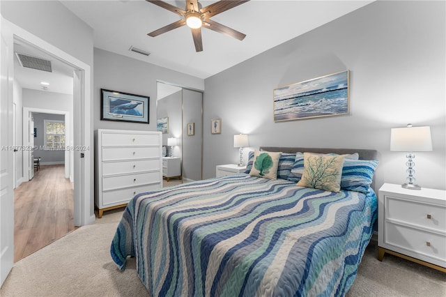 bedroom featuring light hardwood / wood-style floors, a closet, and ceiling fan