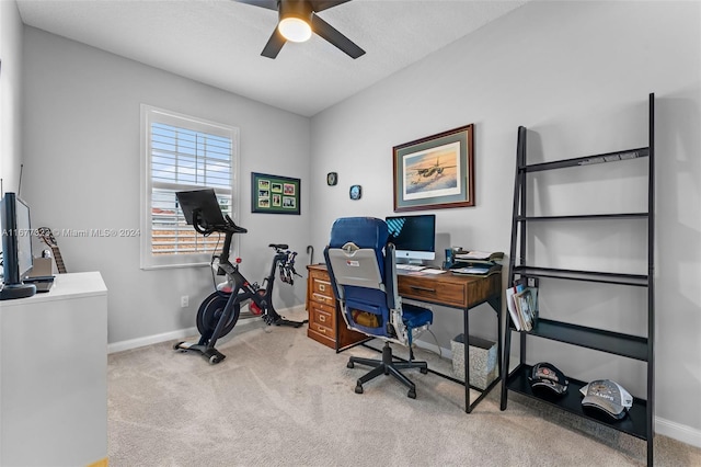 carpeted office space with ceiling fan