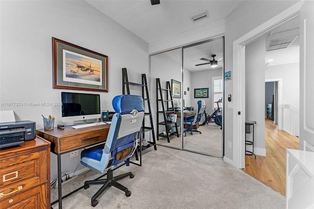 carpeted home office with ceiling fan