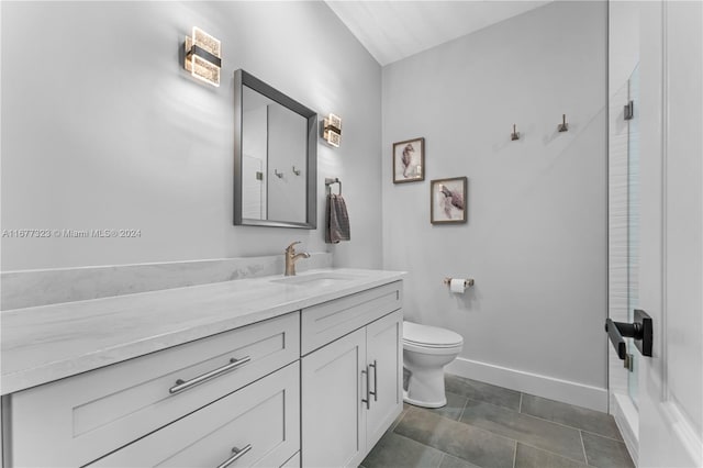 bathroom with toilet, vanity, a shower, and tile patterned flooring