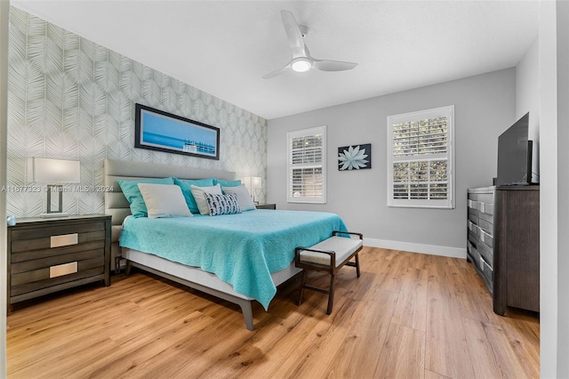 bedroom with ceiling fan and light hardwood / wood-style flooring