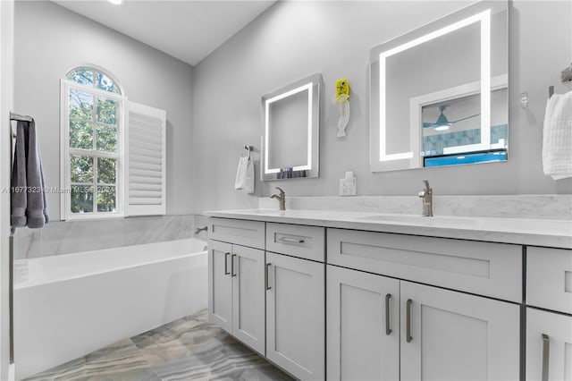 bathroom with vanity and a tub to relax in