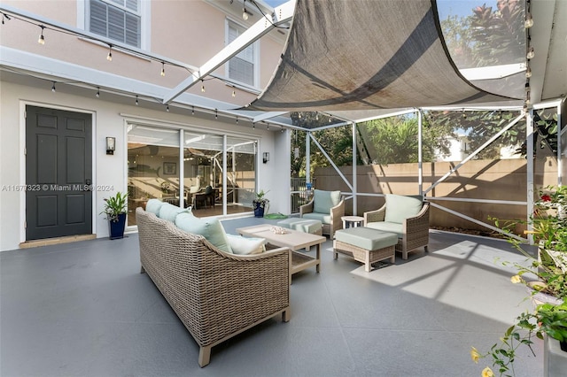 view of patio with outdoor lounge area and a lanai