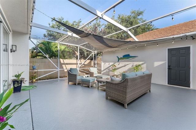 view of patio / terrace featuring outdoor lounge area and glass enclosure