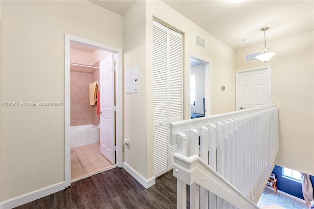 hallway with dark hardwood / wood-style flooring