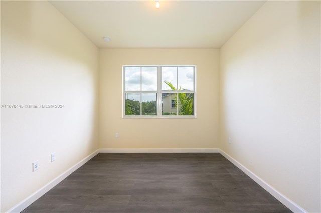 spare room with dark hardwood / wood-style flooring