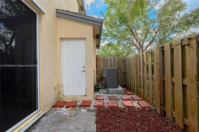 doorway to property with central AC unit