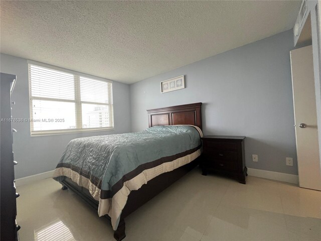 770 Claughton Island Dr Unit 1414, Miami, FL 33131 - bedroom featuring a textured ceiling and baseboards