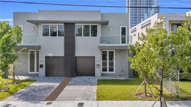 contemporary house with a balcony and a front lawn