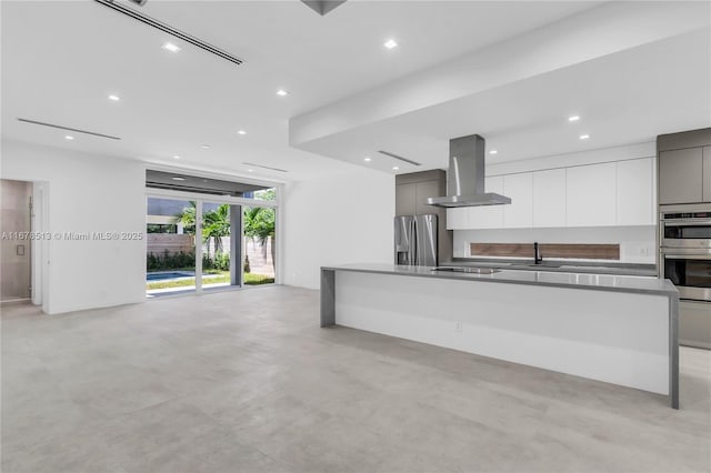 kitchen with range hood, a sink, stainless steel appliances, modern cabinets, and open floor plan