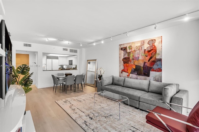 living room featuring track lighting and hardwood / wood-style flooring