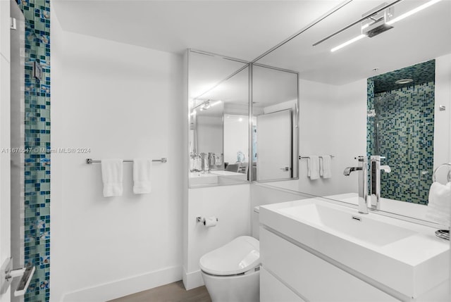 bathroom with vanity, toilet, wood-type flooring, and walk in shower