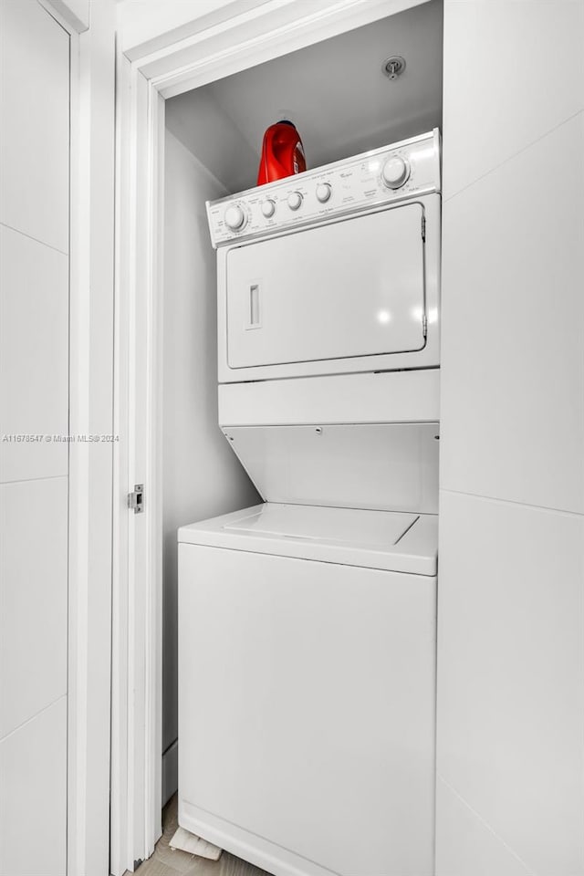 laundry room with stacked washing maching and dryer