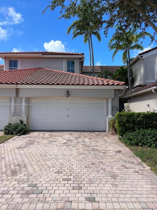 mediterranean / spanish-style house with a garage