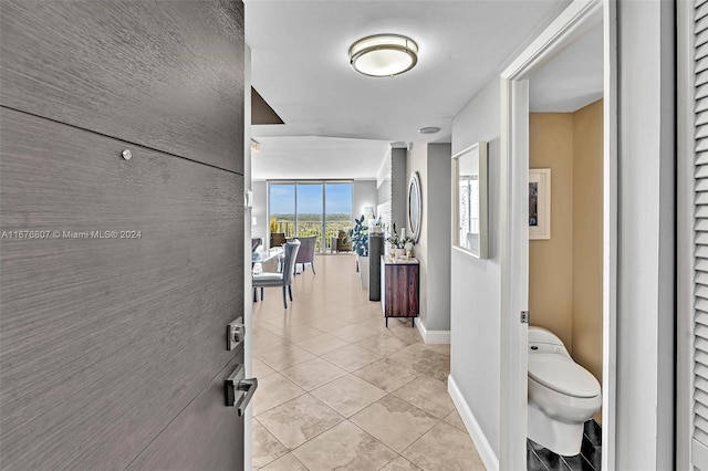 hall with light tile patterned floors