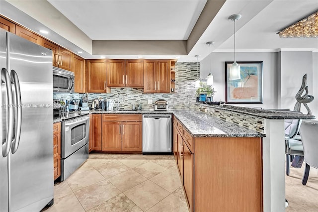 kitchen with sink, stainless steel appliances, decorative light fixtures, dark stone counters, and decorative backsplash