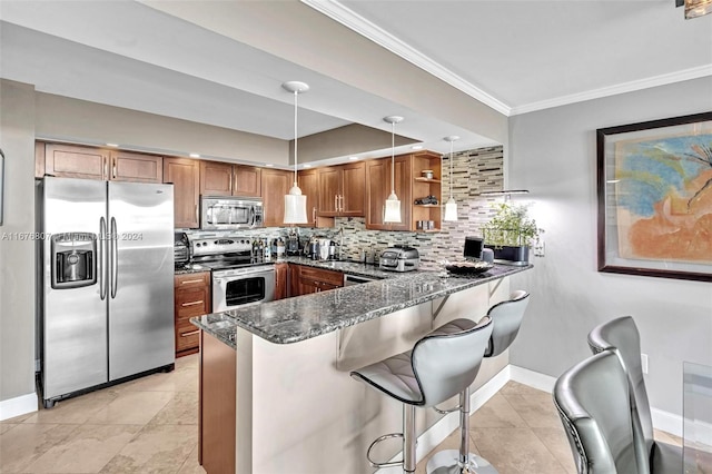 kitchen featuring kitchen peninsula, appliances with stainless steel finishes, dark stone counters, and pendant lighting