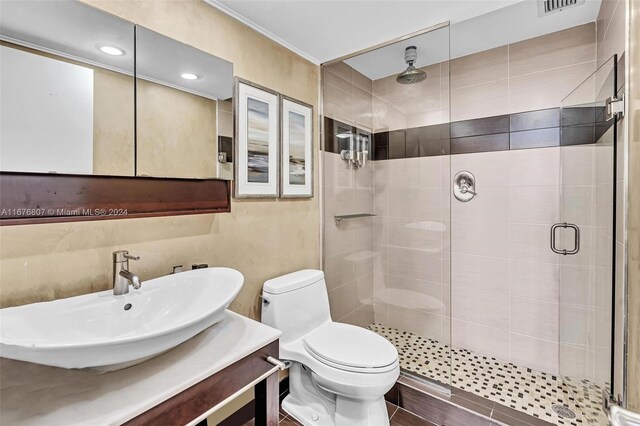 bathroom featuring vanity, hardwood / wood-style floors, a shower with shower door, and toilet